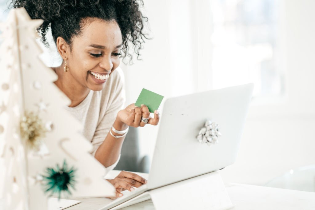 a woman holding a gift card