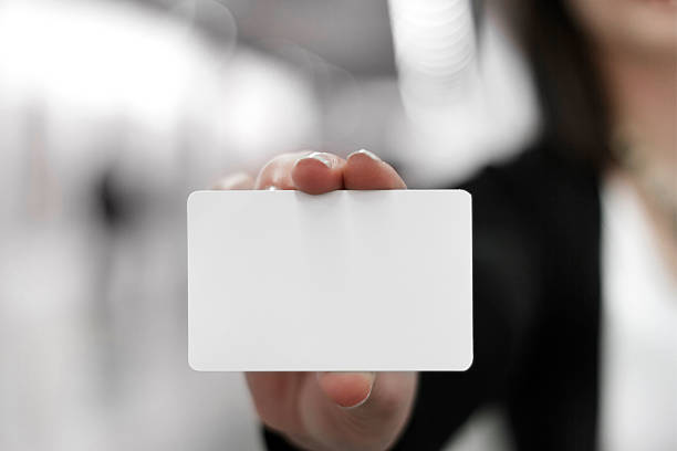 Young woman holding a blank card in her hand