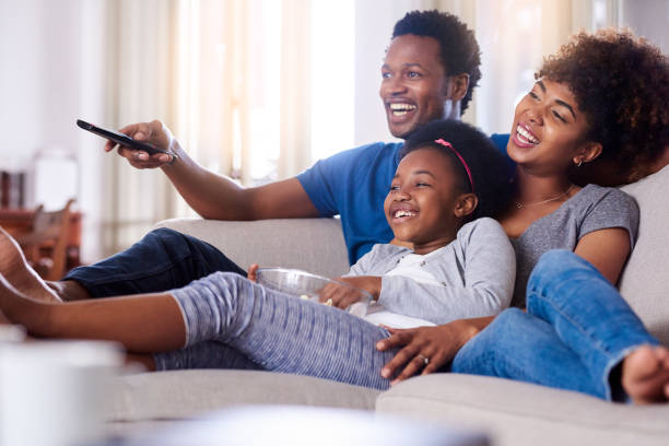 Family watching television together at home